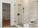 Modern tiled shower with frameless glass and built-in shelves, creating a luxurious bathroom experience at 5361 Mint Harbor Way # 0301, Charlotte, NC 28269