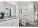 Bright bathroom featuring white tile, a framed shower curtain and vanity with sleek fixtures at 5361 Mint Harbor Way # 0301, Charlotte, NC 28269