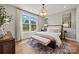 Beautiful bedroom featuring a decorative rug, large window, and stylish furniture at 5361 Mint Harbor Way # 0301, Charlotte, NC 28269