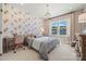Cozy bedroom with floral wallpaper, a window view, and stylish decor at 5361 Mint Harbor Way # 0301, Charlotte, NC 28269