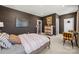 Spacious bedroom featuring dark accent wall, white trim, and a comfortable bed with a modern desk at 5361 Mint Harbor Way # 0301, Charlotte, NC 28269