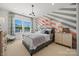 Bright bedroom features an accent wall, large window, and modern chandelier lighting at 5361 Mint Harbor Way # 0301, Charlotte, NC 28269