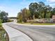Scenic drive leading to the stone-built 'Griffith Lakes' community entrance, surrounded by autumn foliage at 5361 Mint Harbor Way # 0301, Charlotte, NC 28269