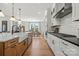 Modern kitchen with stainless steel appliances, large sink, and adjacent dining area at 5361 Mint Harbor Way # 0301, Charlotte, NC 28269