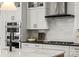 Modern kitchen with sleek white cabinetry, stainless steel appliances, and a gas cooktop at 5361 Mint Harbor Way # 0301, Charlotte, NC 28269