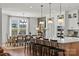 Modern kitchen with a large island, barstool seating, and open to the dining area at 5361 Mint Harbor Way # 0301, Charlotte, NC 28269