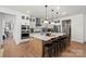 Bright kitchen with white cabinets, large island, and stainless steel appliances at 5361 Mint Harbor Way # 0301, Charlotte, NC 28269