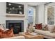 Cozy living room featuring shiplap accent wall, a fireplace, and comfortable seating at 5361 Mint Harbor Way # 0301, Charlotte, NC 28269
