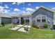 Landscaped backyard featuring potted plants, green lawn and enclosed screened-in porch at 537 Lincoln Quarters Ln, Fort Mill, SC 29708