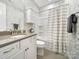 A well-lit bathroom featuring a vanity, toilet, and shower with patterned wallpaper at 537 Lincoln Quarters Ln, Fort Mill, SC 29708