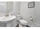 Bathroom featuring patterned wallpaper, a toilet, and a pedestal sink with chrome faucet at 537 Lincoln Quarters Ln, Fort Mill, SC 29708