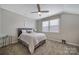 Neutral bedroom with a ceiling fan, carpeted floor, large window, and Queen bed at 537 Lincoln Quarters Ln, Fort Mill, SC 29708