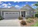 Charming single-story home with a two-car garage and well-maintained landscaping with colorful plants at 537 Lincoln Quarters Ln, Fort Mill, SC 29708