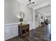 Inviting entryway with hardwood floors, decorative table, accent mirror, and elegant wainscoting at 537 Lincoln Quarters Ln, Fort Mill, SC 29708