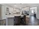 Modern kitchen with an island with seating, stainless steel appliances, and ample cabinet space, perfect for cooking at 537 Lincoln Quarters Ln, Fort Mill, SC 29708