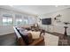 Relaxing living room featuring a large television, comfortable seating, and ample natural light at 537 Lincoln Quarters Ln, Fort Mill, SC 29708