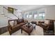 Comfortable living room with leather seating, large windows and natural light at 537 Lincoln Quarters Ln, Fort Mill, SC 29708