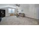 Living room with gray carpet, ceiling fan, and sofa with decorative pillows at 537 Lincoln Quarters Ln, Fort Mill, SC 29708