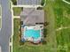 Community pool with lounge chairs and umbrellas surrounded by lush landscaping in a well-maintained area at 537 Lincoln Quarters Ln, Fort Mill, SC 29708