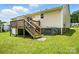 Exterior view of backyard deck and stairs, with an AC unit next to the house at 8106 Strawberry Point Dr, Charlotte, NC 28215