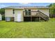 Backyard view featuring a wooden deck with stairs and access to the home's exterior door at 8106 Strawberry Point Dr, Charlotte, NC 28215