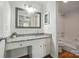 Charming bathroom vanity with granite countertop and a framed mirror, plus shower and tub combo at 8106 Strawberry Point Dr, Charlotte, NC 28215