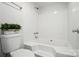 Bright bathroom featuring a clean white tub, and shower combo, plus a modern low-flow toilet at 8106 Strawberry Point Dr, Charlotte, NC 28215