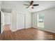 Inviting bedroom features hardwood floors, a ceiling fan, and a closet with lots of storage space at 8106 Strawberry Point Dr, Charlotte, NC 28215