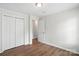 Bedroom featuring hardwood floors, closet, and adjoining door to another room for flexible living at 8106 Strawberry Point Dr, Charlotte, NC 28215
