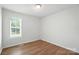 Sunlit bedroom with hardwood floors and bright window brings the beauty of the outdoors inside at 8106 Strawberry Point Dr, Charlotte, NC 28215