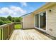 Wooden deck with sliding glass doors, providing a tranquil view of the landscaped yard at 8106 Strawberry Point Dr, Charlotte, NC 28215