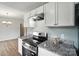 Well-equipped kitchen with granite countertops, stove, and white cabinetry at 8106 Strawberry Point Dr, Charlotte, NC 28215