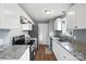 Modern kitchen featuring granite countertops, stainless steel appliances, and white cabinets at 8106 Strawberry Point Dr, Charlotte, NC 28215