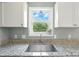 Kitchen area with granite countertops, stainless steel sink, and natural lighting at 8106 Strawberry Point Dr, Charlotte, NC 28215