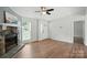Bright living room boasts hardwood floors, a stone fireplace, and backyard views at 8106 Strawberry Point Dr, Charlotte, NC 28215