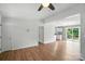 Open living room with a slider to the deck and view into kitchen at 8106 Strawberry Point Dr, Charlotte, NC 28215