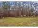 Expansive backyard featuring mature trees and lush green grass at 105 Whimbrel Ln, Mooresville, NC 28117