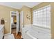 Relaxing bathroom with a soaking tub, hardwood floors, and an adjoining bedroom at 105 Whimbrel Ln, Mooresville, NC 28117