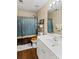 Well-lit bathroom featuring a white vanity, a toilet, and a shower with a blue patterned shower curtain at 105 Whimbrel Ln, Mooresville, NC 28117