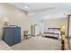 Spacious bedroom featuring plush carpeting, a wooden bed frame with a decorative quilt, and ample closet space at 105 Whimbrel Ln, Mooresville, NC 28117