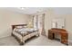 Cozy bedroom with neutral walls, a decorative quilt, and a vanity sitting next to a window at 105 Whimbrel Ln, Mooresville, NC 28117