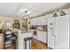 Bright kitchen featuring white cabinets, stainless appliances, eat in counter, and barstool seating at 105 Whimbrel Ln, Mooresville, NC 28117
