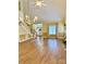 Bright living room with hardwood floors, a fireplace, and grand staircase with large windows at 105 Whimbrel Ln, Mooresville, NC 28117
