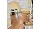 Bright open living space featuring hardwood floors, a fireplace, and adjacent staircase to upper level at 105 Whimbrel Ln, Mooresville, NC 28117