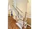 Carpeted staircase with wooden handrails, connecting the home's levels, leading to the upper floor at 105 Whimbrel Ln, Mooresville, NC 28117