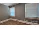 Neutral bedroom featuring wood floors and natural light from two windows at 1904 E Innes St, Salisbury, NC 28146
