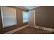 Neutral bedroom featuring wood floors, white trim, and a white door at 1904 E Innes St, Salisbury, NC 28146