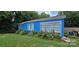 Charming blue home with white window frames and a manicured lawn at 1904 E Innes St, Salisbury, NC 28146