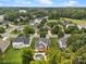 Aerial view of a neighborhood with lush green trees and a pool in the backyard at 191 Harris Farm Rd, Mooresville, NC 28115