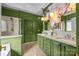 Stylish bathroom with green walls, double vanity, a walk-in shower, and unique wallpaper at 191 Harris Farm Rd, Mooresville, NC 28115